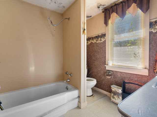 bathroom with tile flooring, shower / tub combination, and toilet