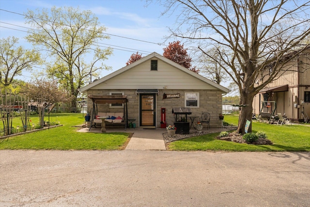 bungalow-style home featuring a front yard