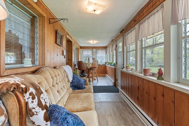 sunroom featuring a baseboard heating unit