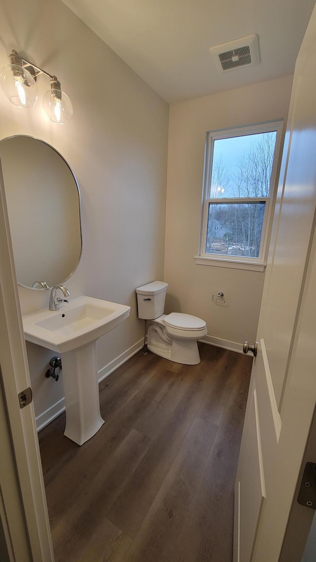 bathroom featuring sink, wood-type flooring, and toilet