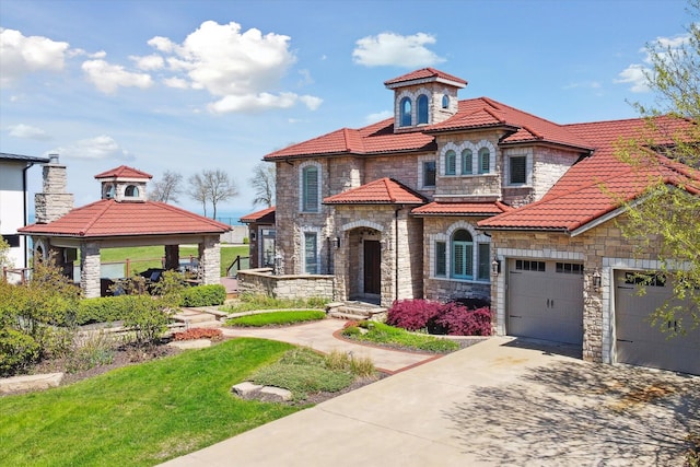 mediterranean / spanish home with a garage and a gazebo