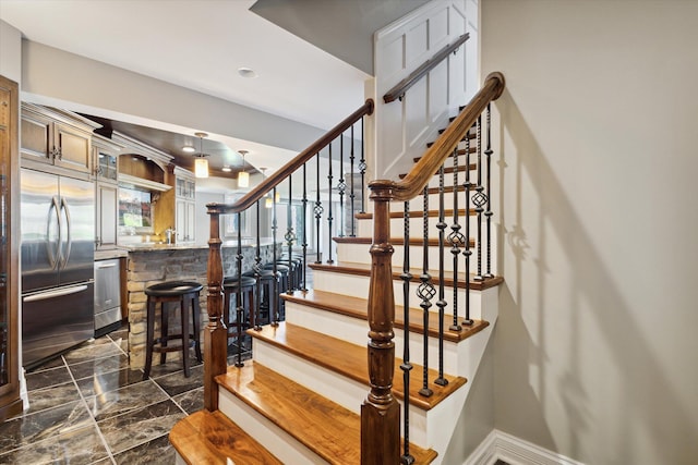 stairway with dark tile flooring