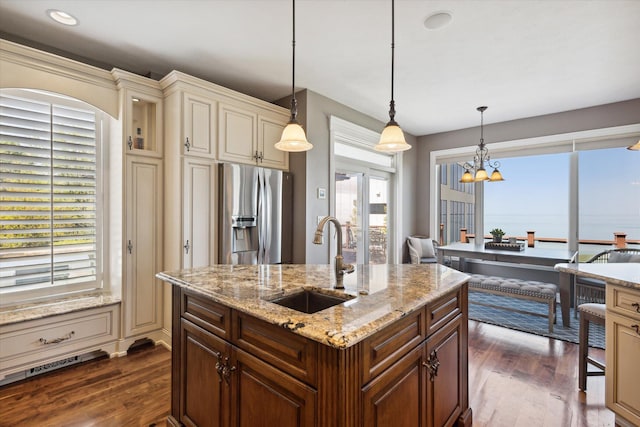 kitchen with decorative light fixtures, sink, stainless steel refrigerator with ice dispenser, and dark wood-type flooring