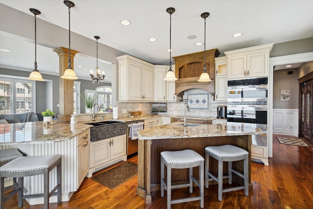 kitchen featuring backsplash, a wealth of natural light, and decorative light fixtures