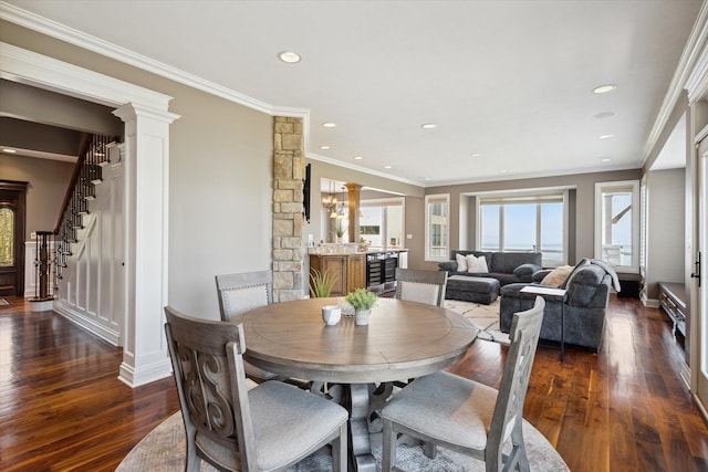 dining area featuring crown molding, dark hardwood / wood-style floors, and decorative columns