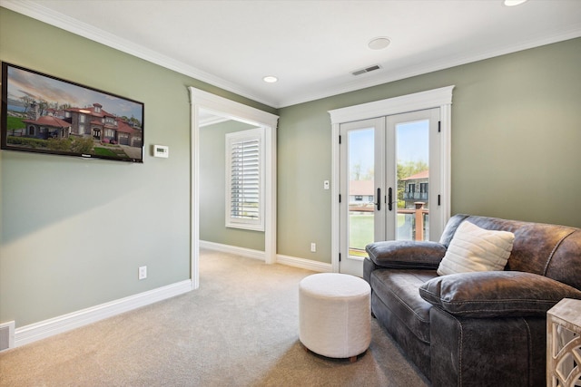 living area with a wealth of natural light, french doors, carpet, and ornamental molding