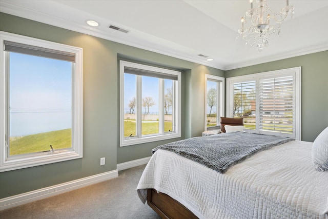 bedroom with carpet flooring, crown molding, an inviting chandelier, and multiple windows