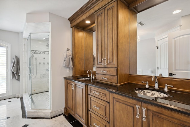 bathroom with tile flooring, walk in shower, and double sink vanity