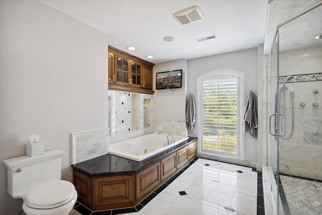 bathroom with tile floors, toilet, and separate shower and tub