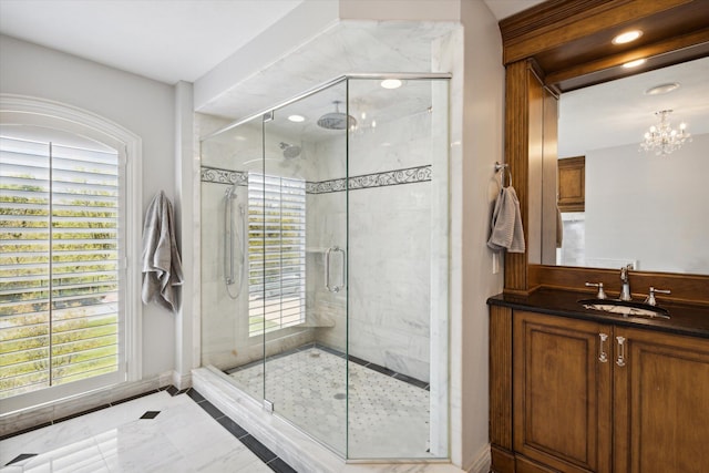 bathroom featuring sink, a shower with shower door, tile floors, and a chandelier