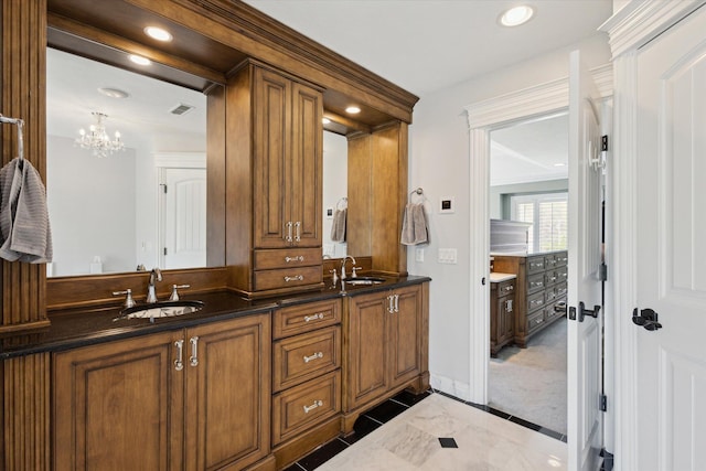 bathroom with tile flooring, a notable chandelier, and dual vanity