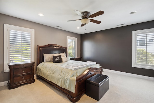 bedroom featuring carpet, ceiling fan, and multiple windows