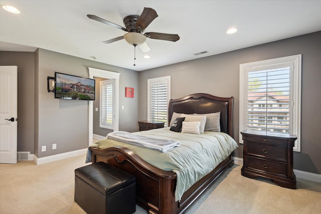 bedroom featuring ceiling fan and light carpet