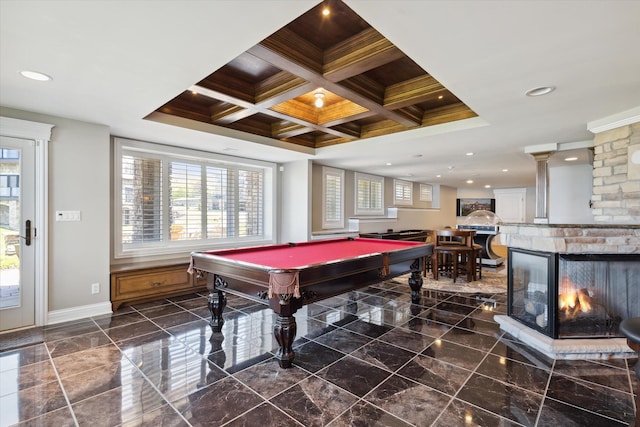 game room with dark tile floors, a fireplace, a wealth of natural light, and pool table