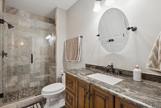 bathroom featuring tile floors, vanity, an enclosed shower, and toilet