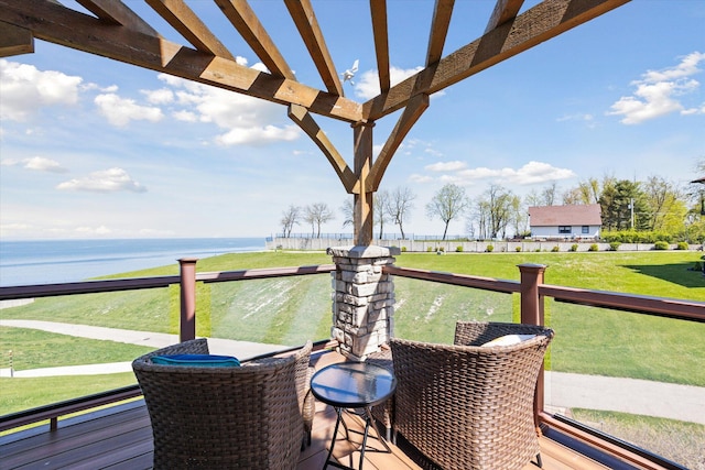 deck with a yard, a water view, and a pergola