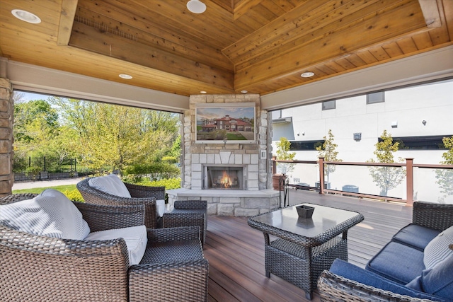 deck with an outdoor living space with a fireplace