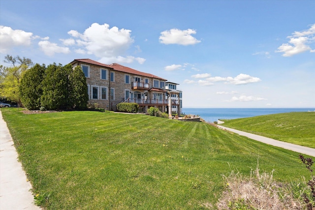 exterior space with a front lawn and a water view