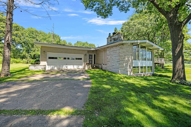 view of front of property featuring a garage and a front lawn