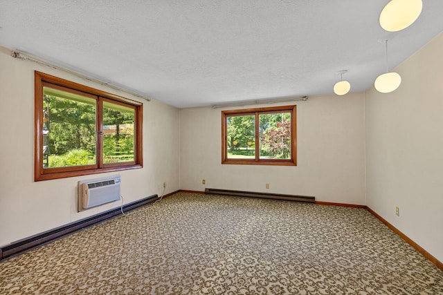 empty room featuring a baseboard heating unit, a wall unit AC, and a healthy amount of sunlight