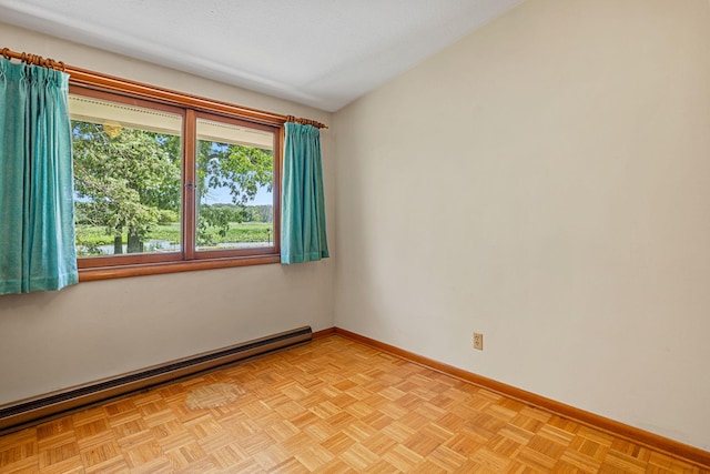 unfurnished room featuring a baseboard radiator and light parquet floors