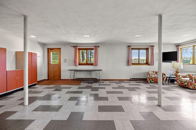 basement featuring a textured ceiling