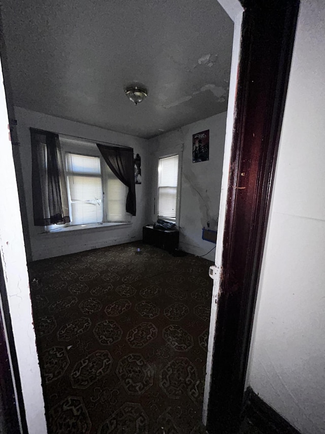 hallway with a textured ceiling