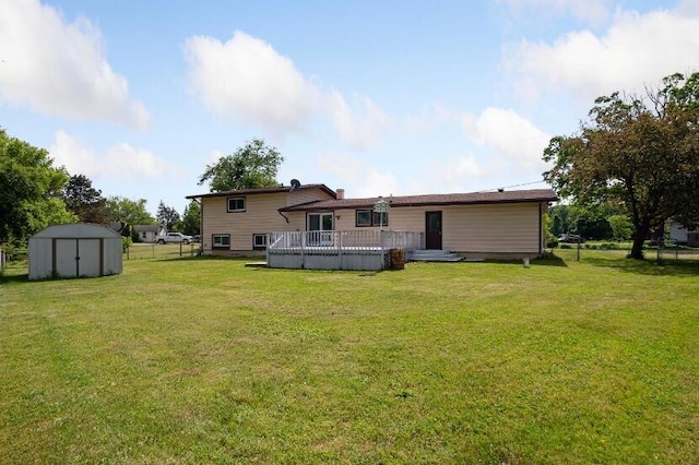 back of property featuring a deck, a storage shed, and a yard