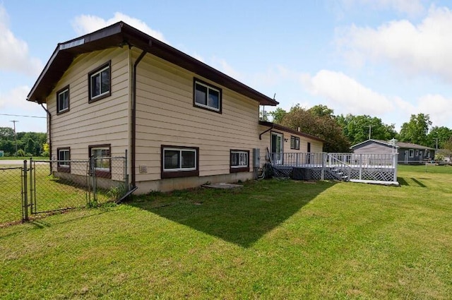 rear view of property featuring a lawn