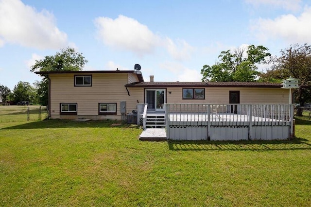 back of property featuring a lawn and a wooden deck