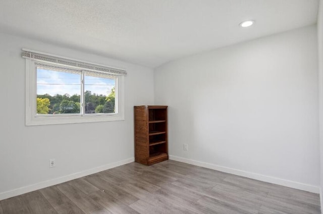 empty room with wood-type flooring