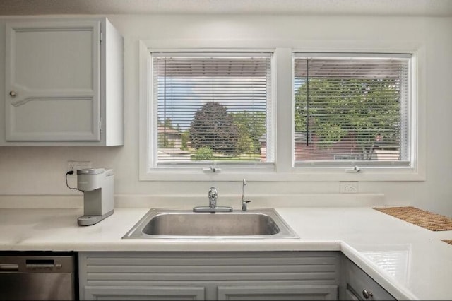 kitchen with dishwasher, sink, and gray cabinets