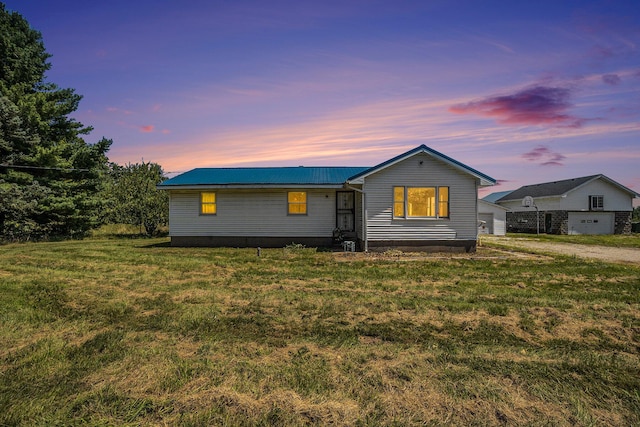 single story home with a lawn