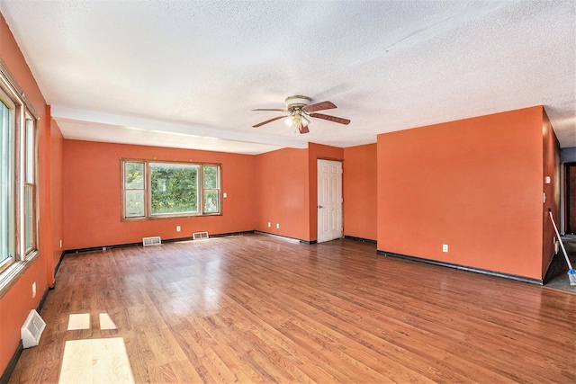 unfurnished room featuring ceiling fan, a textured ceiling, and light hardwood / wood-style floors