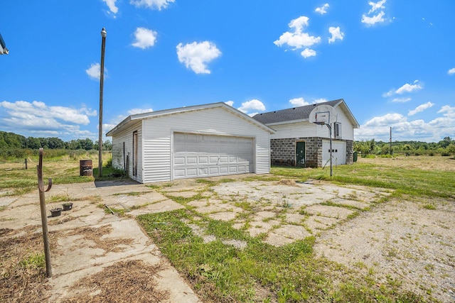 view of side of home featuring a garage and an outdoor structure