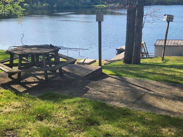 exterior space featuring a water view and a lawn