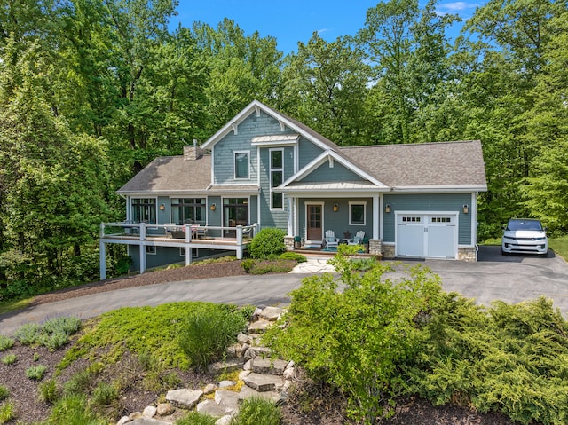 view of front of home with a garage and a porch