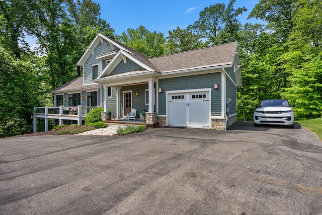 craftsman house with a porch and a garage