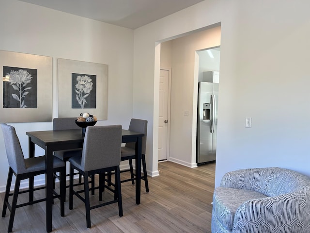 dining space featuring wood-type flooring