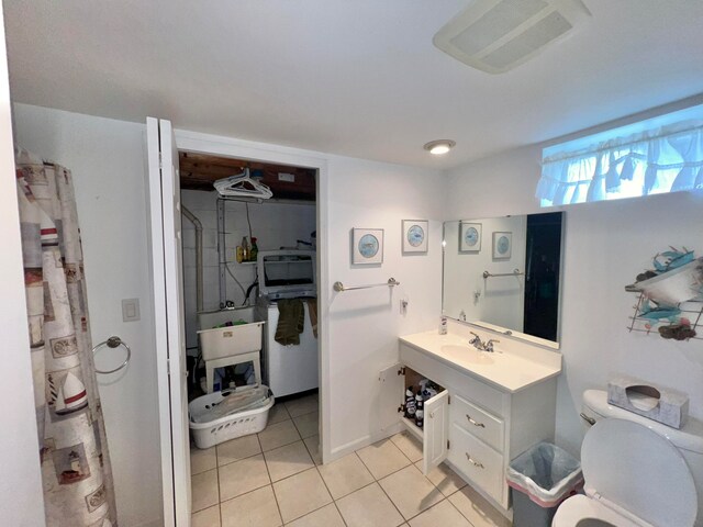 bathroom with tile flooring, large vanity, and toilet