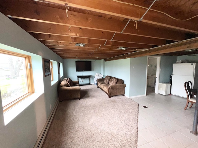 basement with tile flooring and white fridge