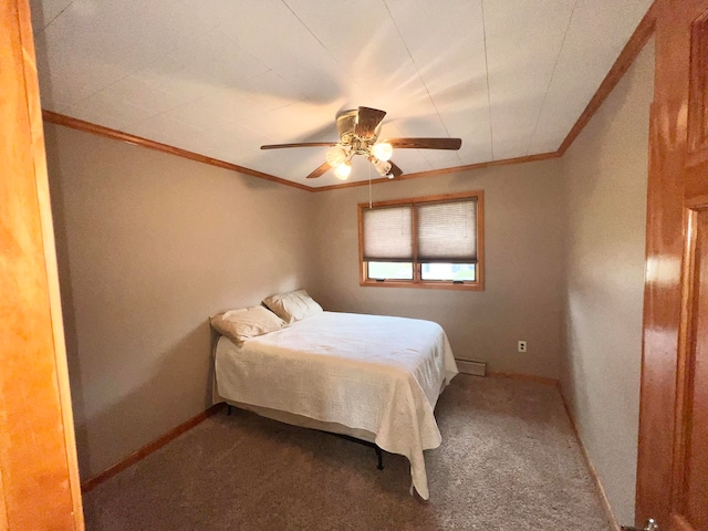 carpeted bedroom featuring a baseboard heating unit and ceiling fan