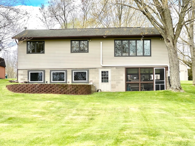 rear view of house with a yard