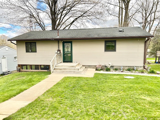 view of front of house featuring a front lawn and a shed