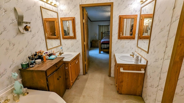 bathroom with a bathing tub, oversized vanity, and double sink