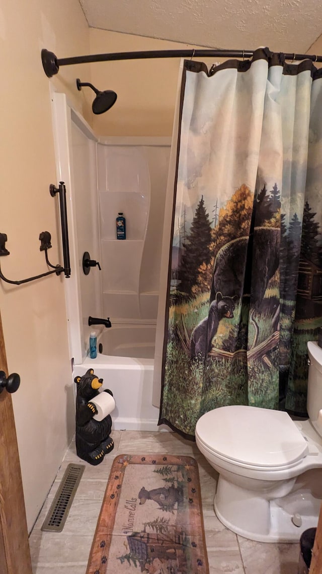 bathroom featuring tile flooring, toilet, and shower / tub combo with curtain