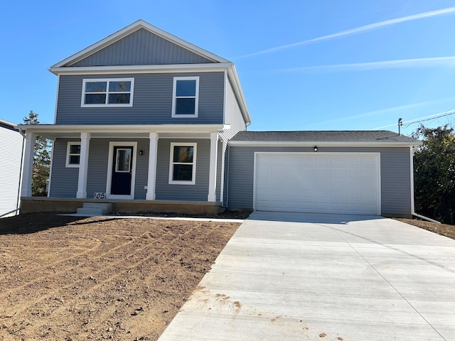 view of front property featuring a garage and a porch