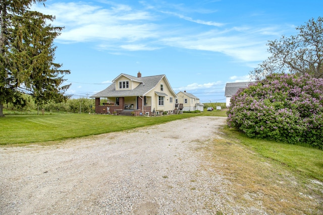 view of front of property with a front yard and covered porch