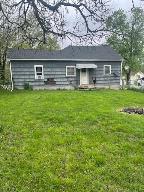 back of property with a yard