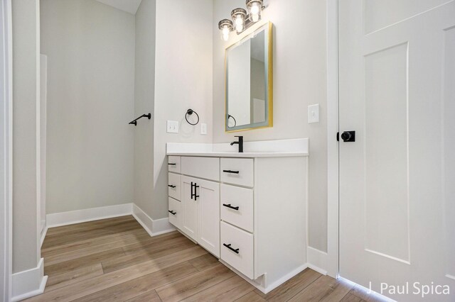 bathroom with hardwood / wood-style flooring and vanity